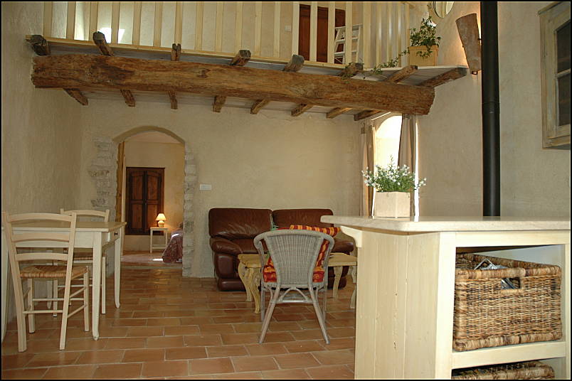 Kitchen and living room with ancient beams and posts